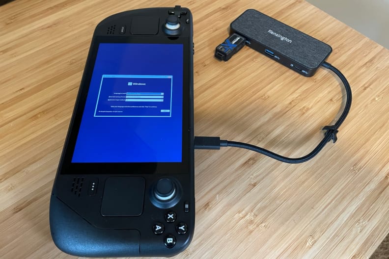 A black handheld game console showing part of the Windows 11 operating system installation process