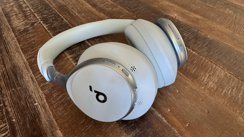 The Anker Soundcore Space One headphones in sky blue on a wooden coffee table.