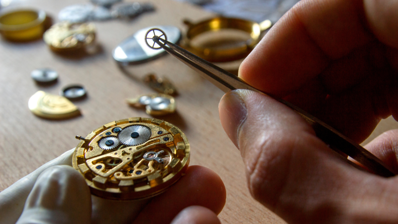 man working on repairing a mechanical watch