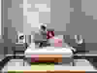 A couple sitting on a Tuft and Needle mattress.