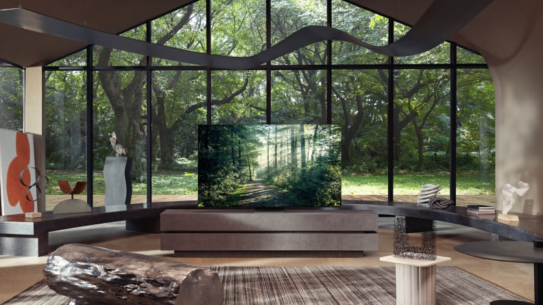 A Samsung QLED TV displaying a forest