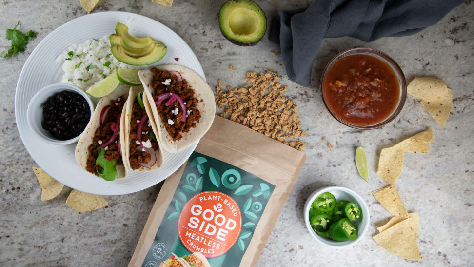 A spread of tacos made with Goodside Meatless Crumbles, with the product bag visible