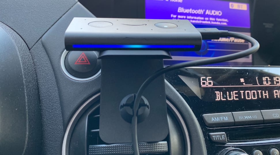Amazon's Echo Auto sits on top of an air vent mount inside of a car.
