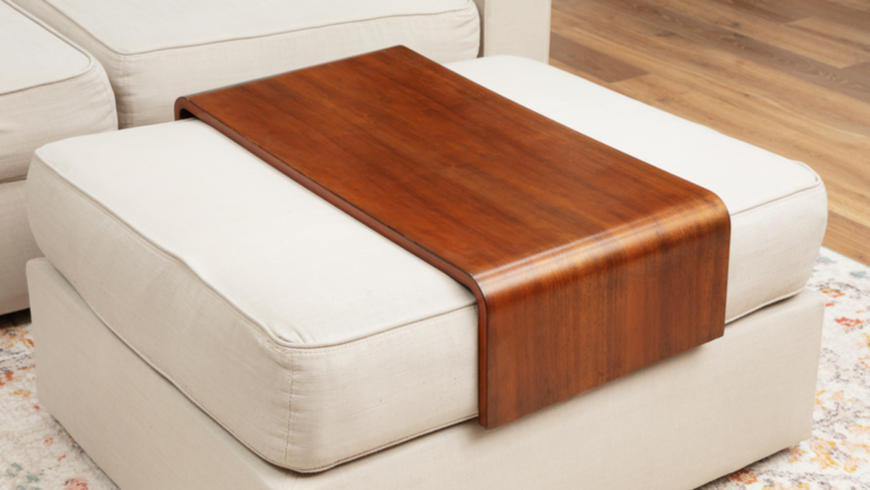 A u-shaped wood table fits over the ottoman in front of the Sactional.
