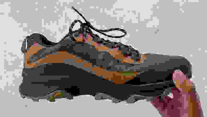 hand holding Merrell Moab Speed shoe