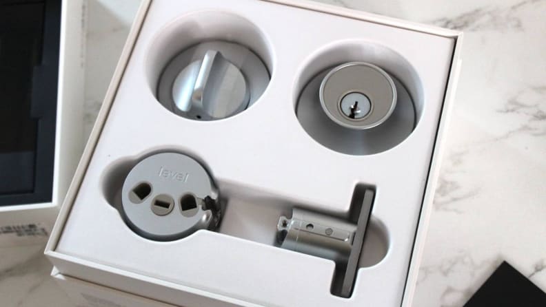 The components of the Level Lock Plus Connect arranged in its packaging.