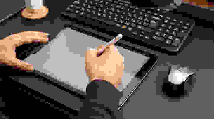 Person using stylus on tablet