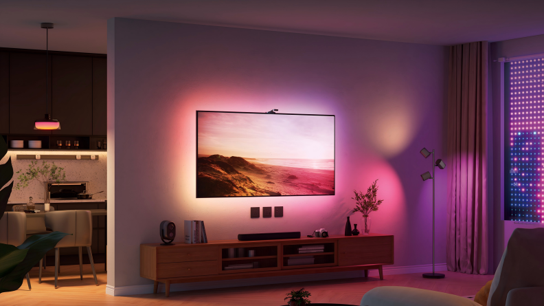 A TV on the wall glows from behind