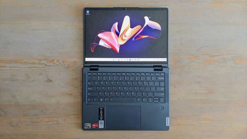 A top-down view of a laptop with its screen laying flat against a table