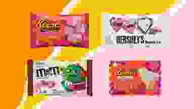 Reese's blossom-top mini cups, Hershey's Cookies 'N' Cream hearts, Reese's White Creme Hearts, and Black Forests M&M's all in their packaging on a pink, orange, and yellow background