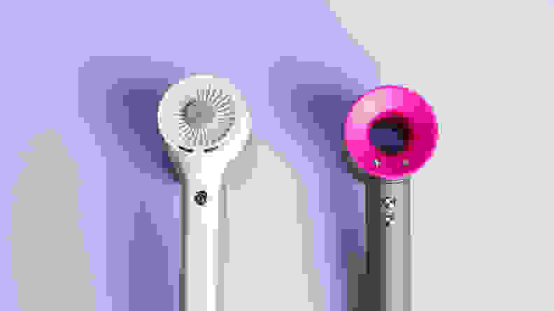 A closeup on the heads of the Shark (left) and Dyson (right) hair dryers.
