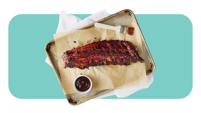 A full rack of gilled ribs served on a platter.