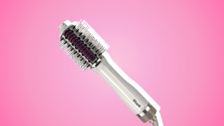 Shark heated comb and straightener against a pink background.