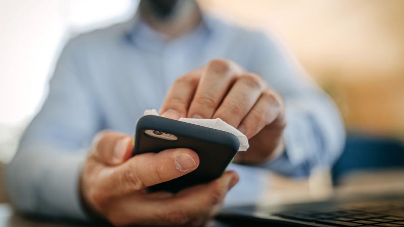 A man cleans his smartphone.