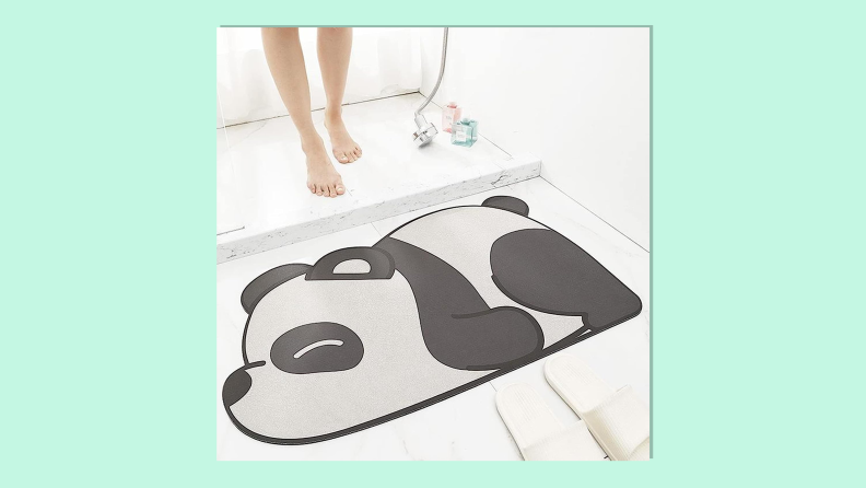 Super absorbent panda bath mat on light green background.