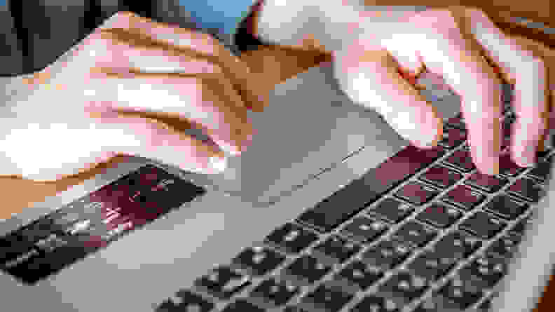 Closeup of person using the laptop trackpad