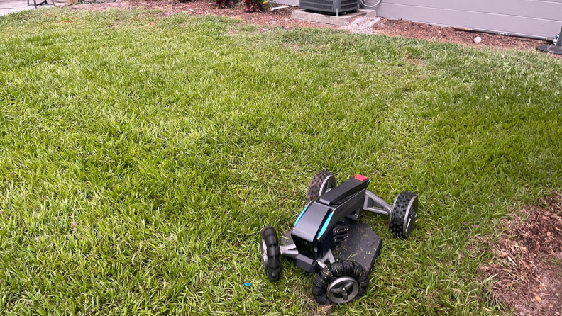 EcoFlow Blade Robotic Lawn Mower on top of freshly cut lawn.