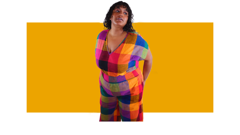 woman in colorful jumpsuit on orange background