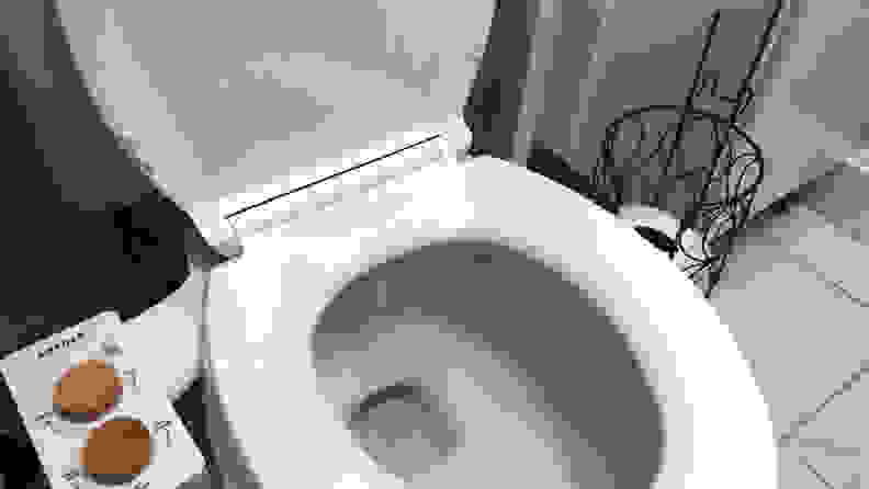 Tushy bidet on open toilet seat