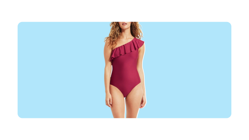 A red one-shoulder one-piece bathing suit with a ruffle.