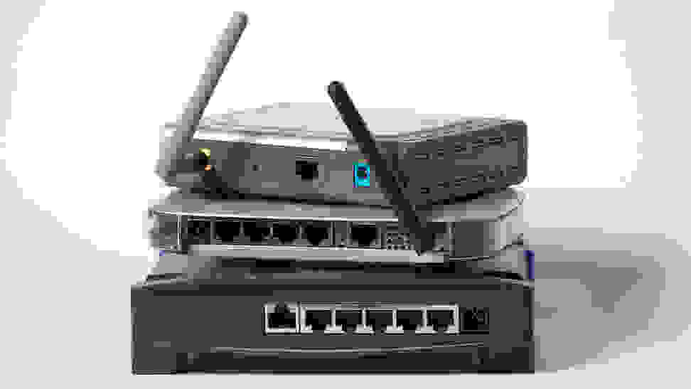 A number of wireless routers, stacked on top of one another.