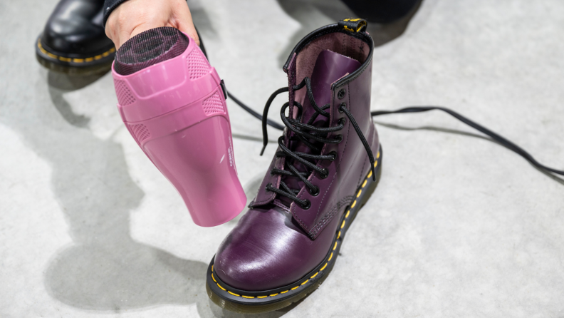 Running a hair dryer on leather boots.