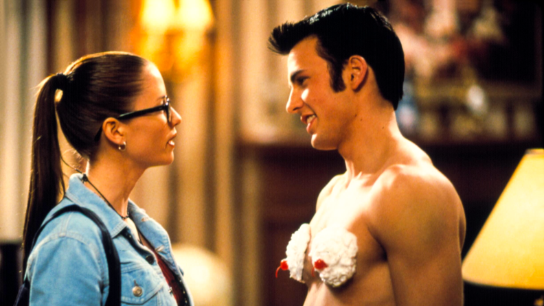 Actors Chris Evans and Chyler Leigh play an unlikely pairing in the 2001 comedy Not Another Teen Movie. Here, Evans stands before Leigh shirtless, with whipped cream and cherries on his chest.