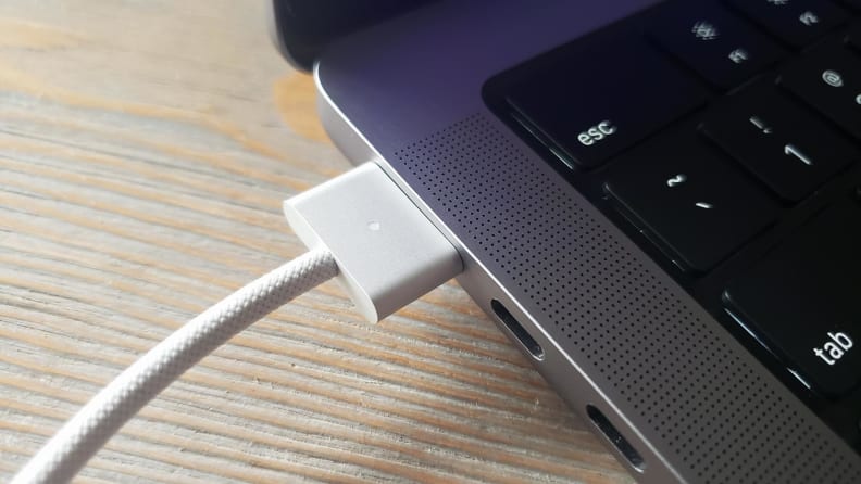 Close-up of the Macbook Pro's charger cable and port.