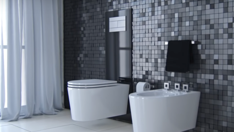 The Oli Easy Move WC toilet in a minimalist bathroom with metallic tile.
