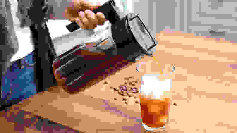 The Takeya cold brew maker pouring cold brew into a glass of ice.