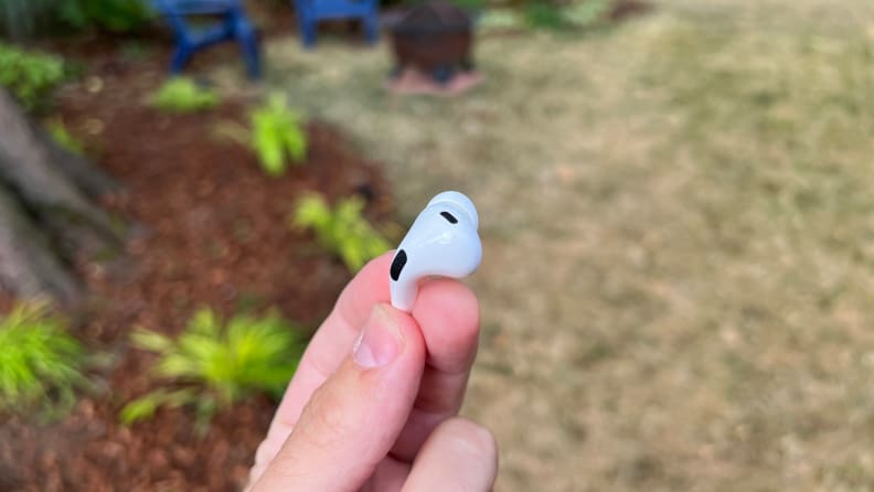 Close-up of the hand holding the single earbud of the Apple AirPods Pro (2nd generation).