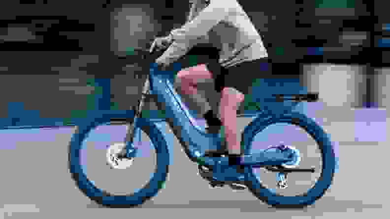 A person in profile rides a Segway Xafari bike.
