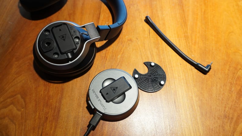 The Turtle Beach Stealth Pro and its USB base station on a wooden desk surface.