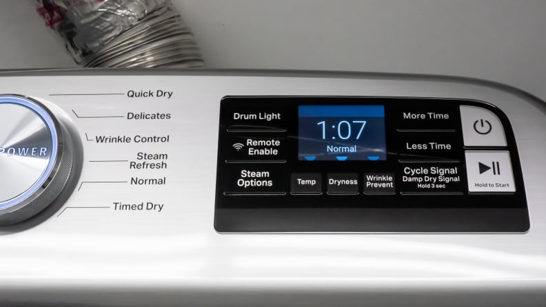 A close-up of the Maytag MED7230HW dryer's control panel, which features a standard large cycle selection dial next to a touchpad for further customization options.