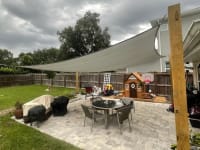A home with a shade sail installed in the backyard.