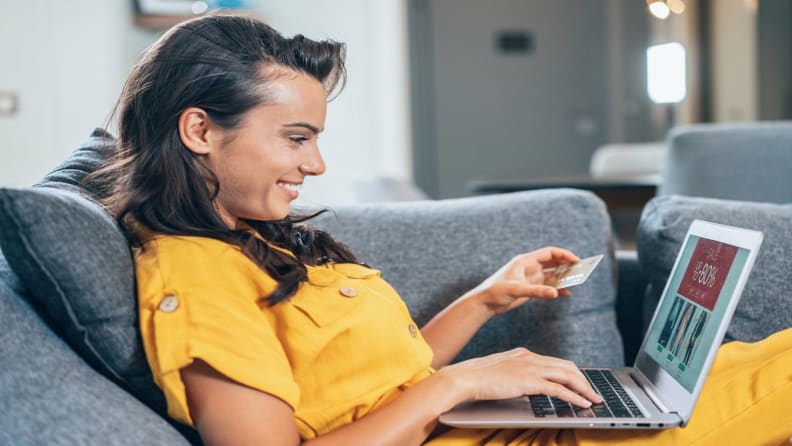 Image of woman scrolling on laptop and shopping online