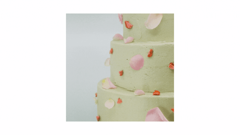 A GIF featuring a layer cake with light green icing, across which the words 