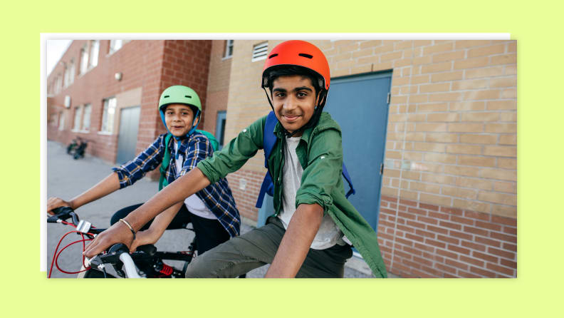 A group of teens on bikes wearing helmets while parked.