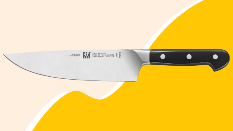 Close up of a knife against a yellow background.