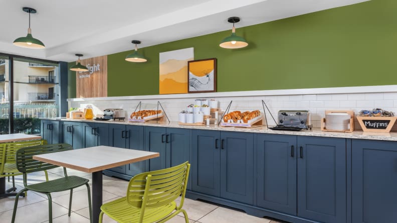 Spark by Hilton breakfast area with pastries, muffins, juice, and modern seating.