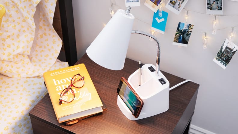 A charging lamp sits on a bedside table.