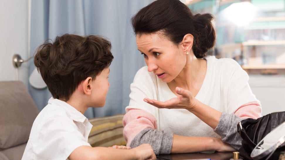 Mother and son sitting at a table talking