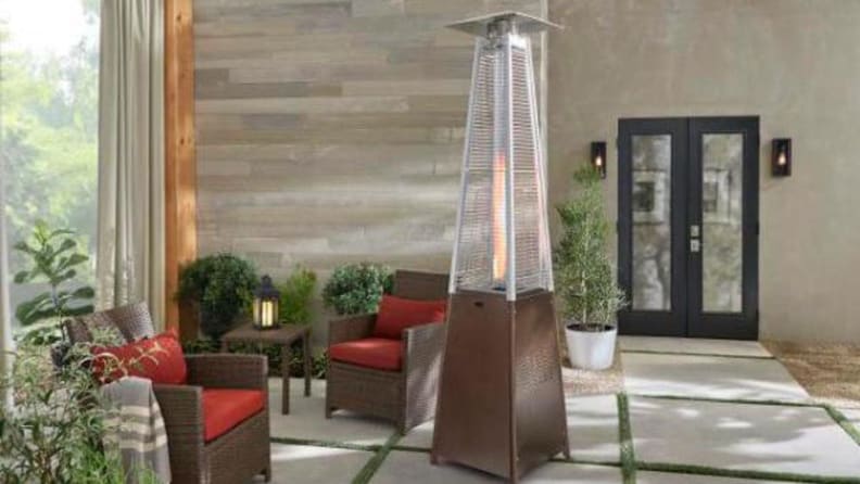 A patio heater lit on a stylish outdoor patio.