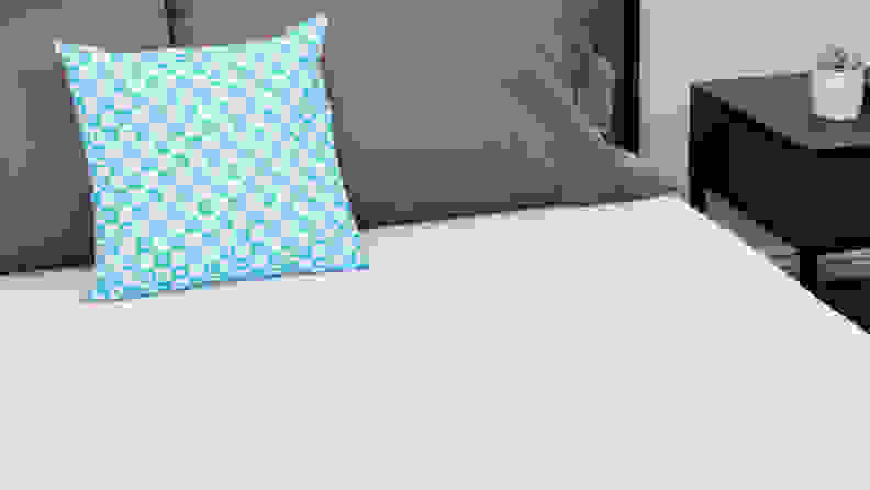 A blue pillow resting on the Tuft & Needle Original mattress