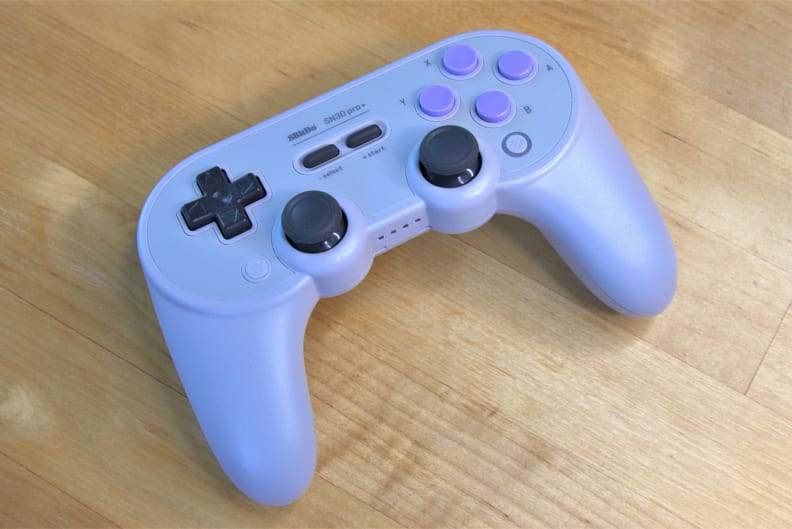 The 8bitdo SN30 Pro controller on a desk.