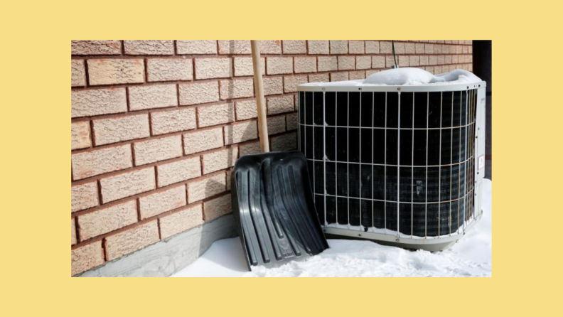 An outdoor air conditioning unit surrounded by snow in the winter.
