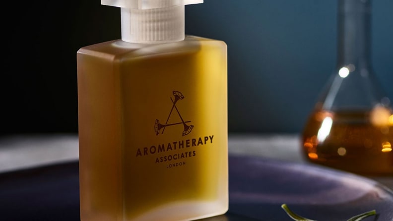 the aromatherapy Deep Relax Bath and Shower Oil on a tray against a blue background
