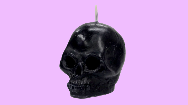 An image of a black wax skull candle.