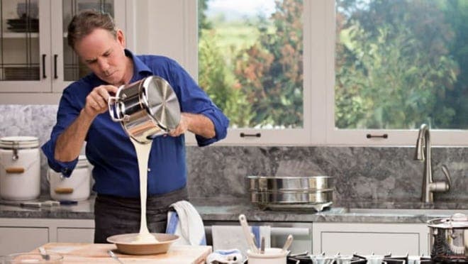 Thomas Keller pouring baking mix in a light kitchen