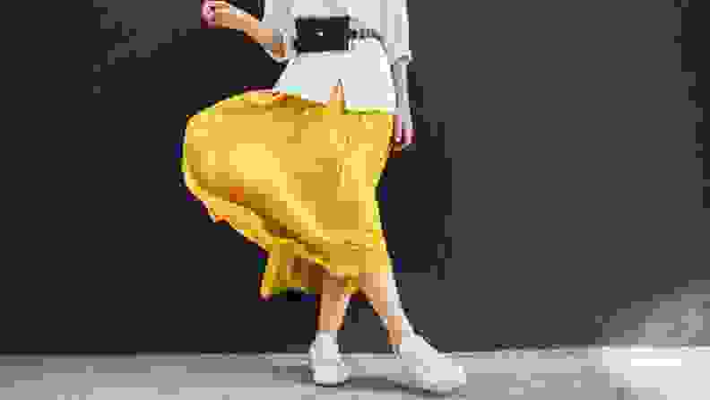 woman in white shirt and long flowy yellow skirt